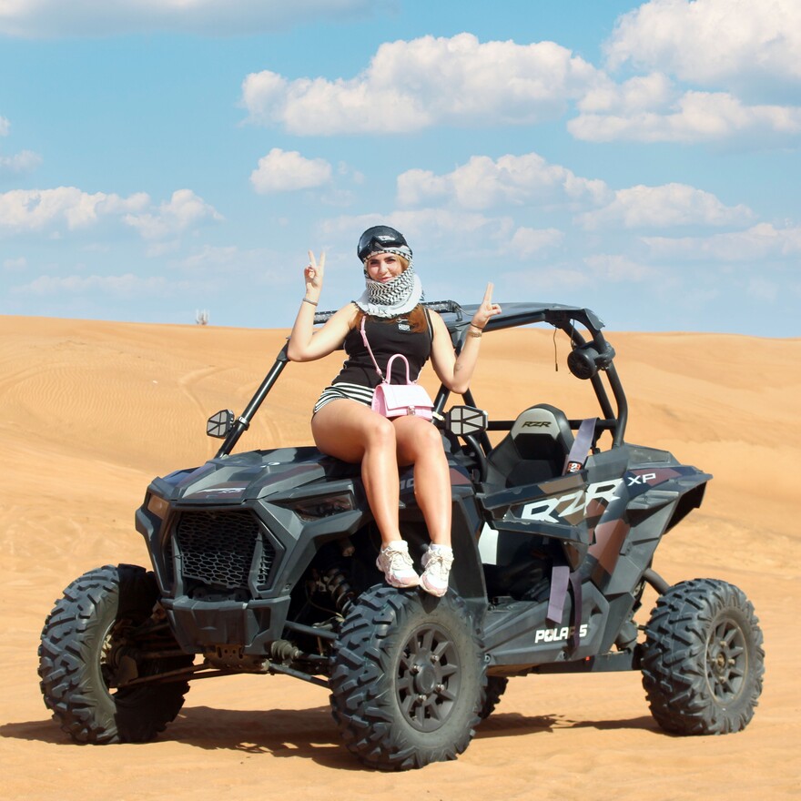 Dune buggy racing through Dubai desert dunes